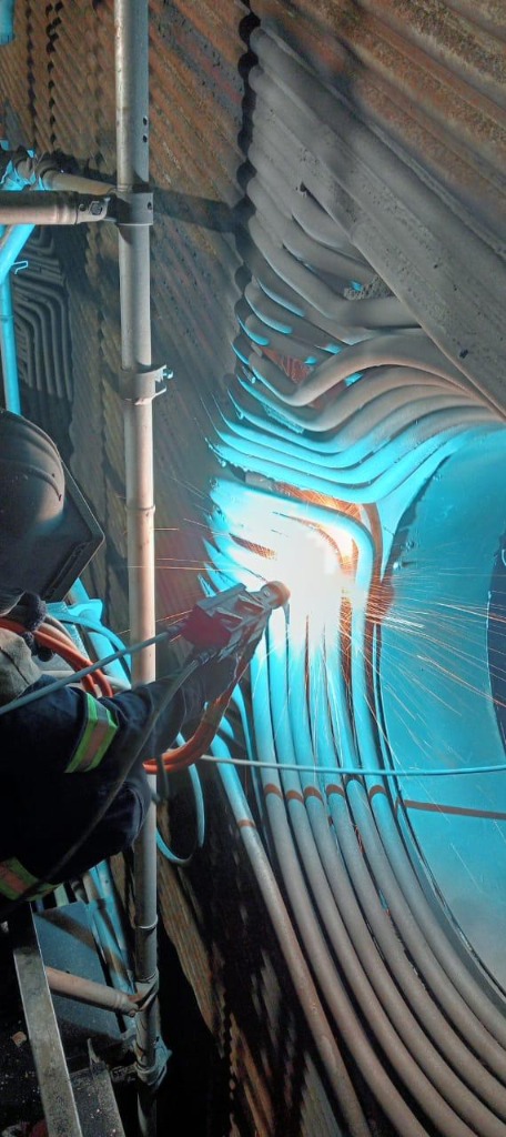 Specialist performing in-situ thermal spray coating on complex tube walls