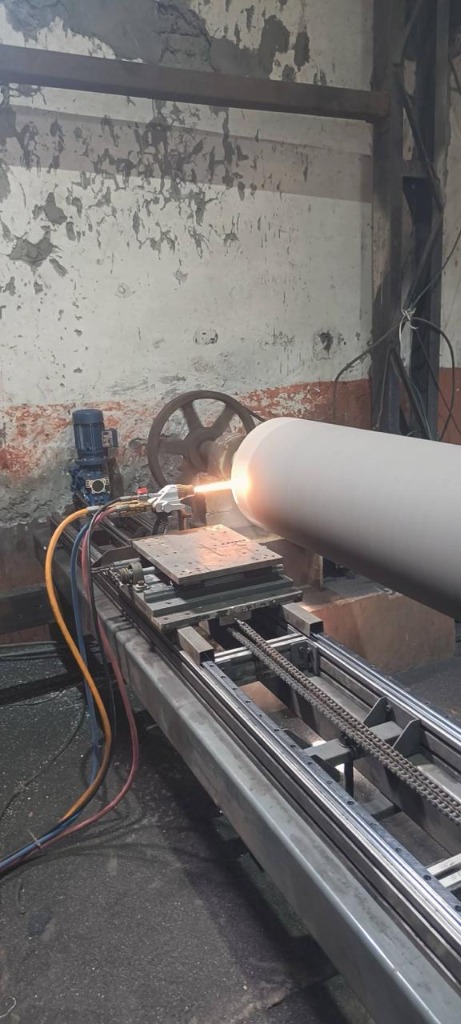 Automated thermal spray coating applied to a rotary component