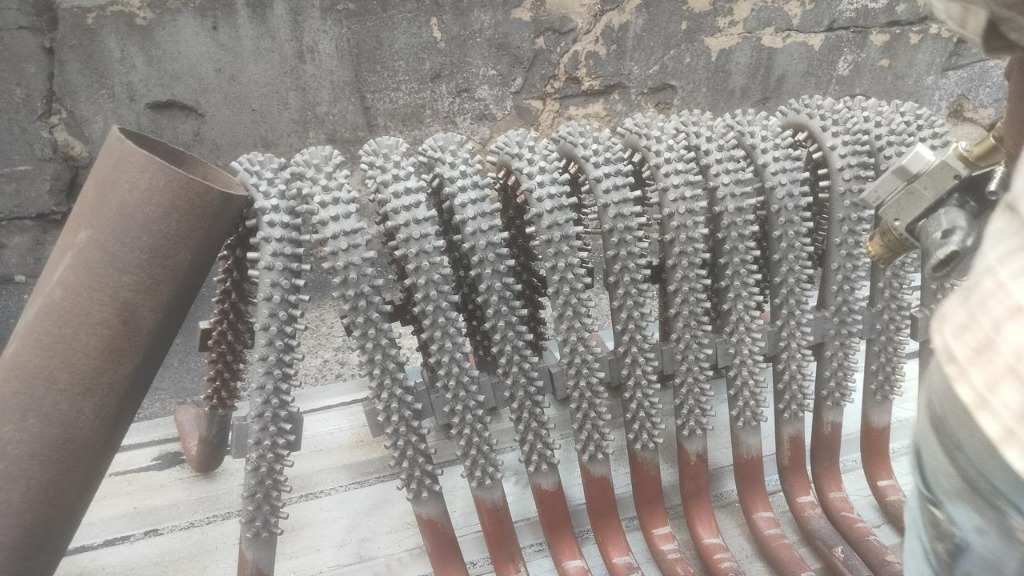 Thermal spray application on studded boiler tubes